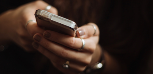 Hands holding a mobile phone